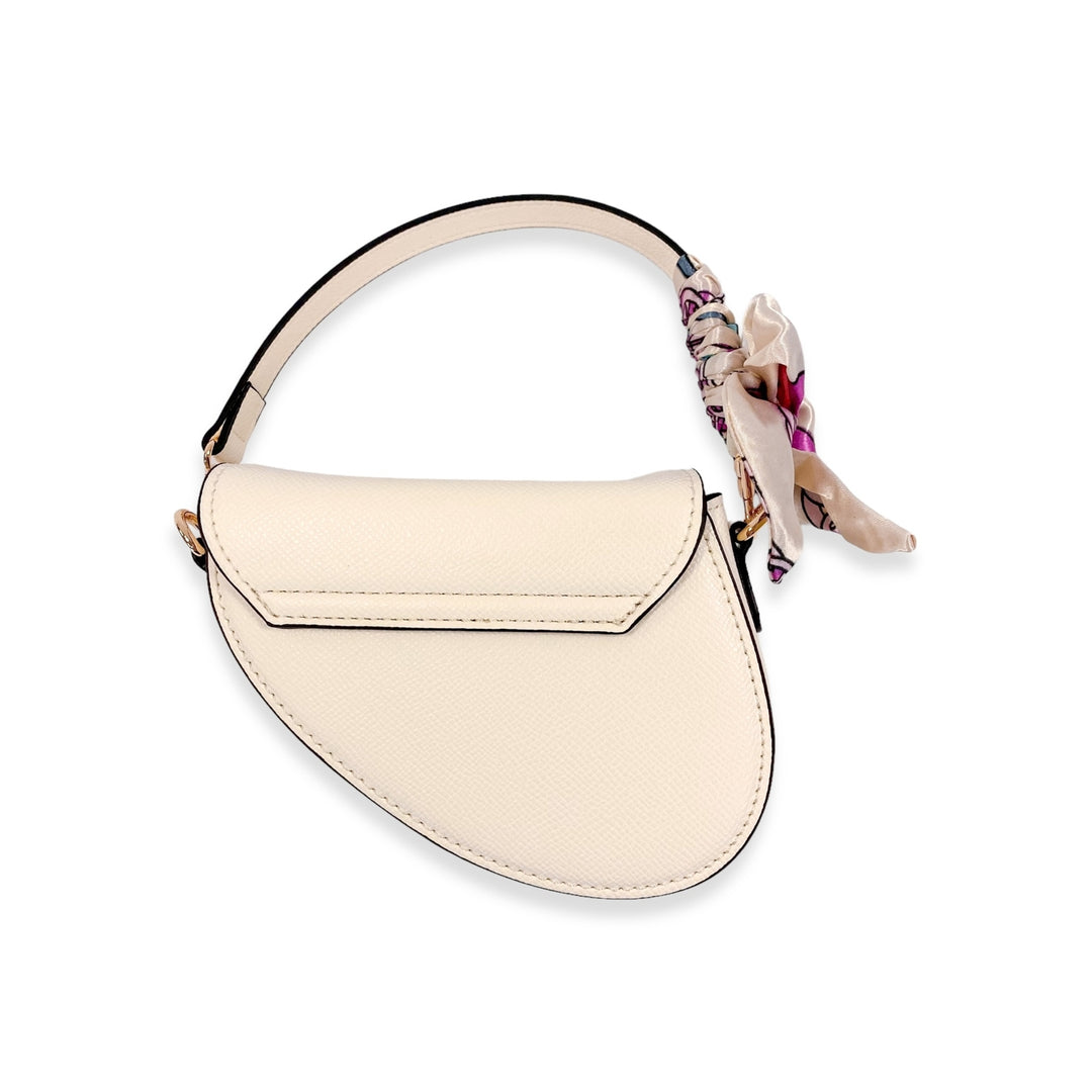 Back of a beige handbag with a scarf on the shoulder strap. 