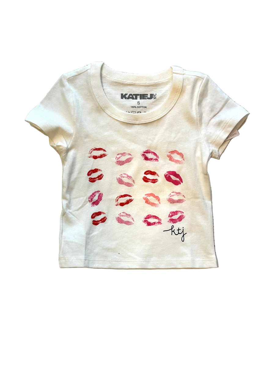 White t-shirt with red lip prints and 'katie j' branding on it 