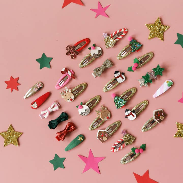 Christmas snap clips all lined up together, trees, reindeer, candy cane, gingerbread house