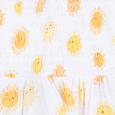 White romper with yellow sun pattern on a white background