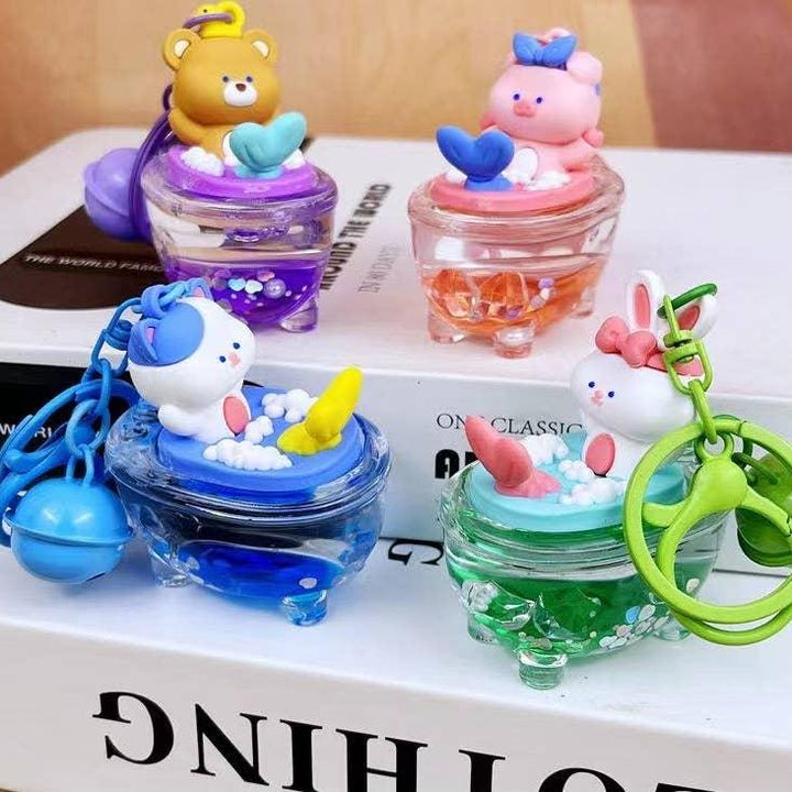 animals in bath tub on a key chain, each animal is in a different color water bathtub. 