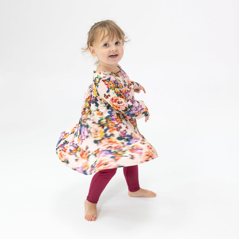 baby girl spinning in her autumn floral dress. the colors look great in motion!