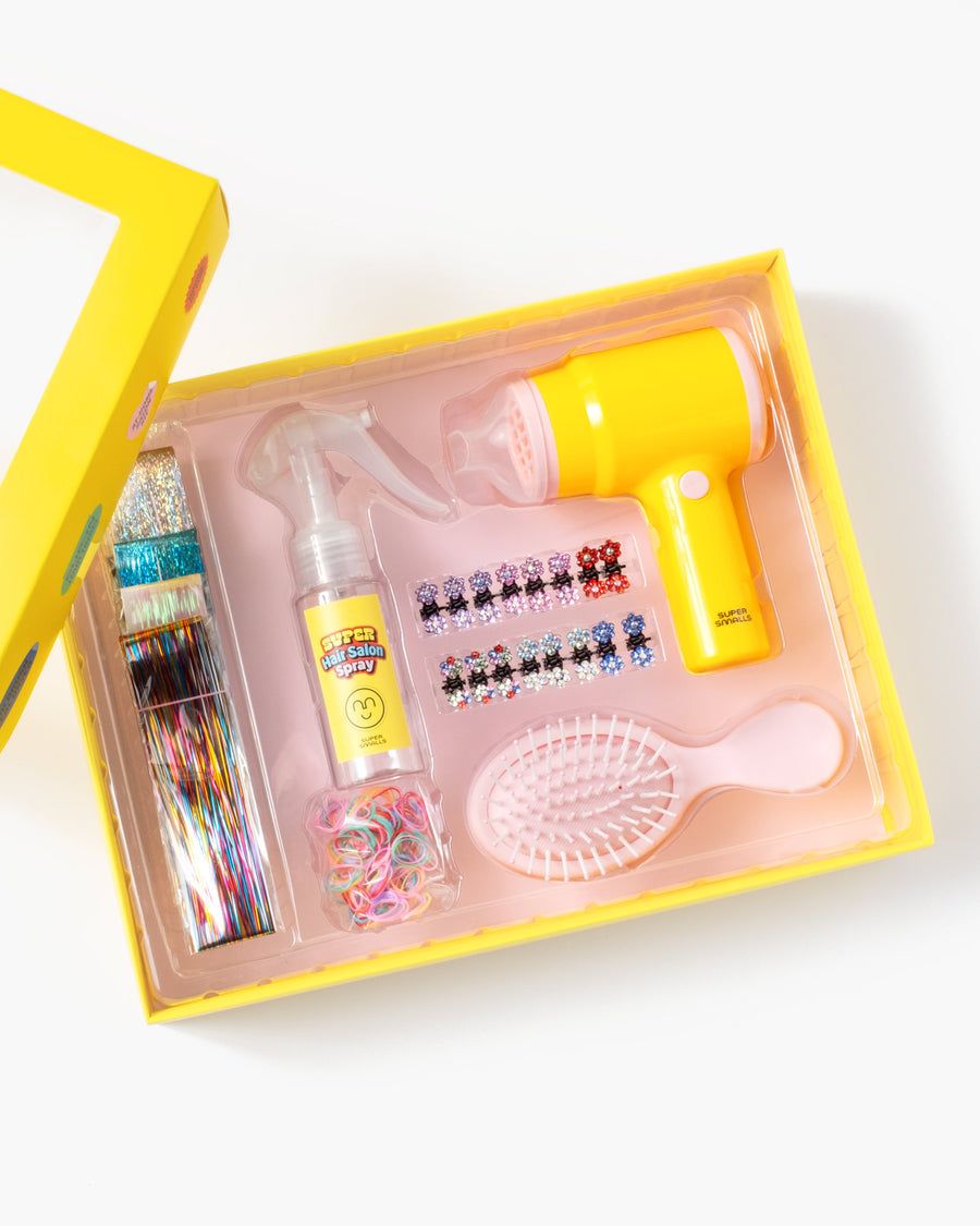 Set of baby care items including a bottle, spray, and other accessories in a yellow box on a white background.