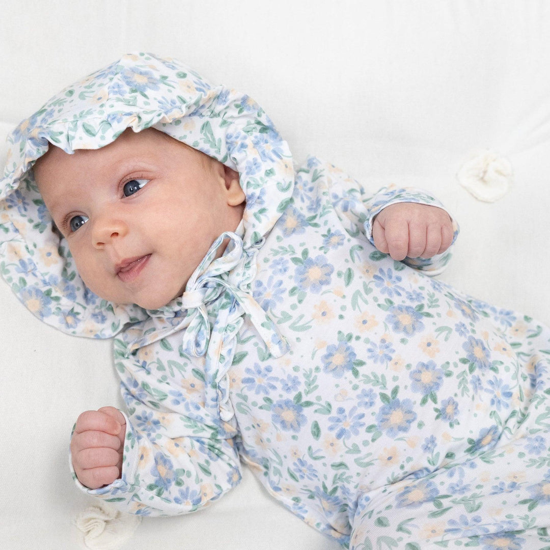 Baby wearing the baby bonnet and baby gown in baby veronical floral. 