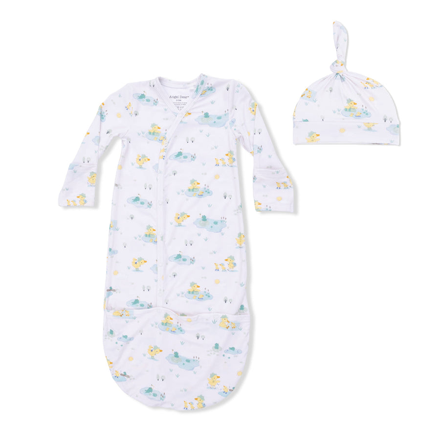 Baby gown and hat set with duck pattern on a white background