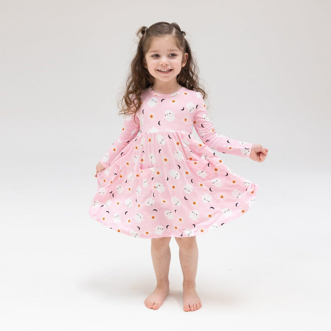 Little girl modeling the pink ghost twirl dress. 