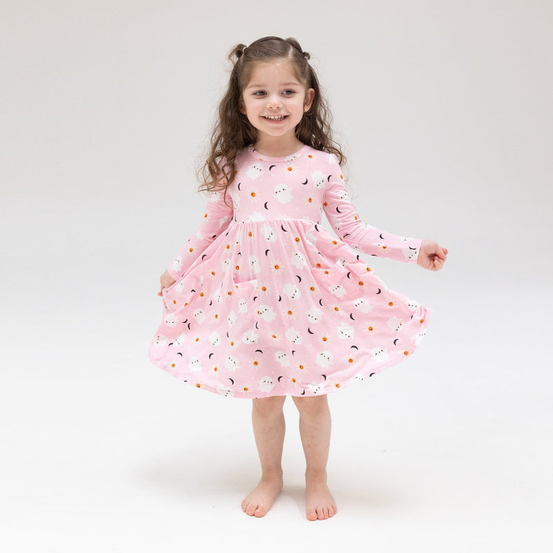 Little girl modeling the pink ghost twirl dress. 