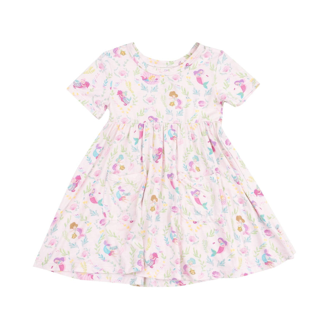 short sleeve twirl dress with pockets on the front and tiny mermaids all over the dress in different pastel colors. mostly shades of pink and purple. 
