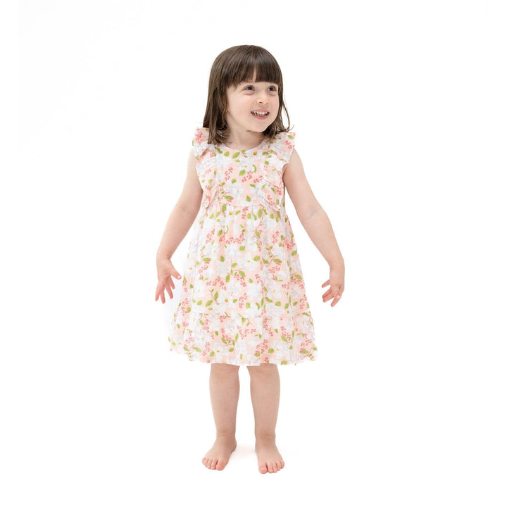 little girl modeling the pink magnolia dress with picot ruffles and lightweigt material. 