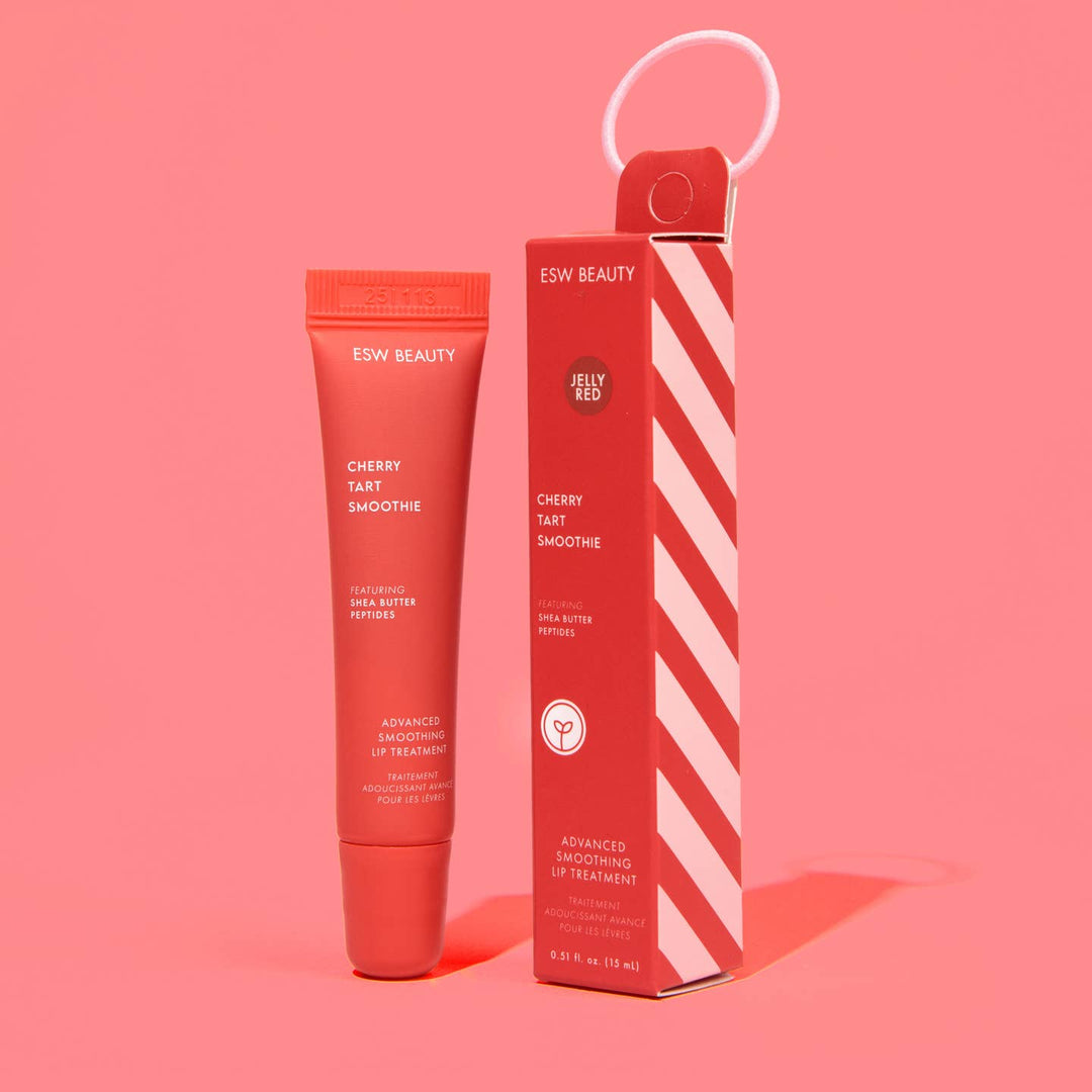 Red lip balm tube and packaging on a pink background