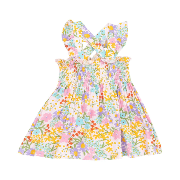 baby girls dress in vibrant floral dress with criss cross straps in yellows, purples and reds and pinks.