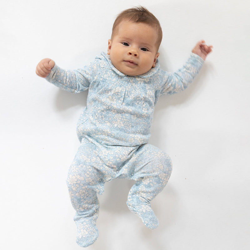 baby modeling the blue floral meadow footie. 