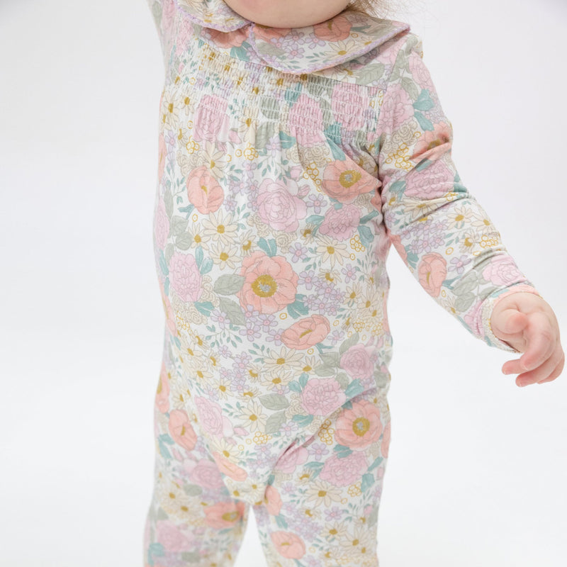 close up of the pastel flower print on this onesie. 