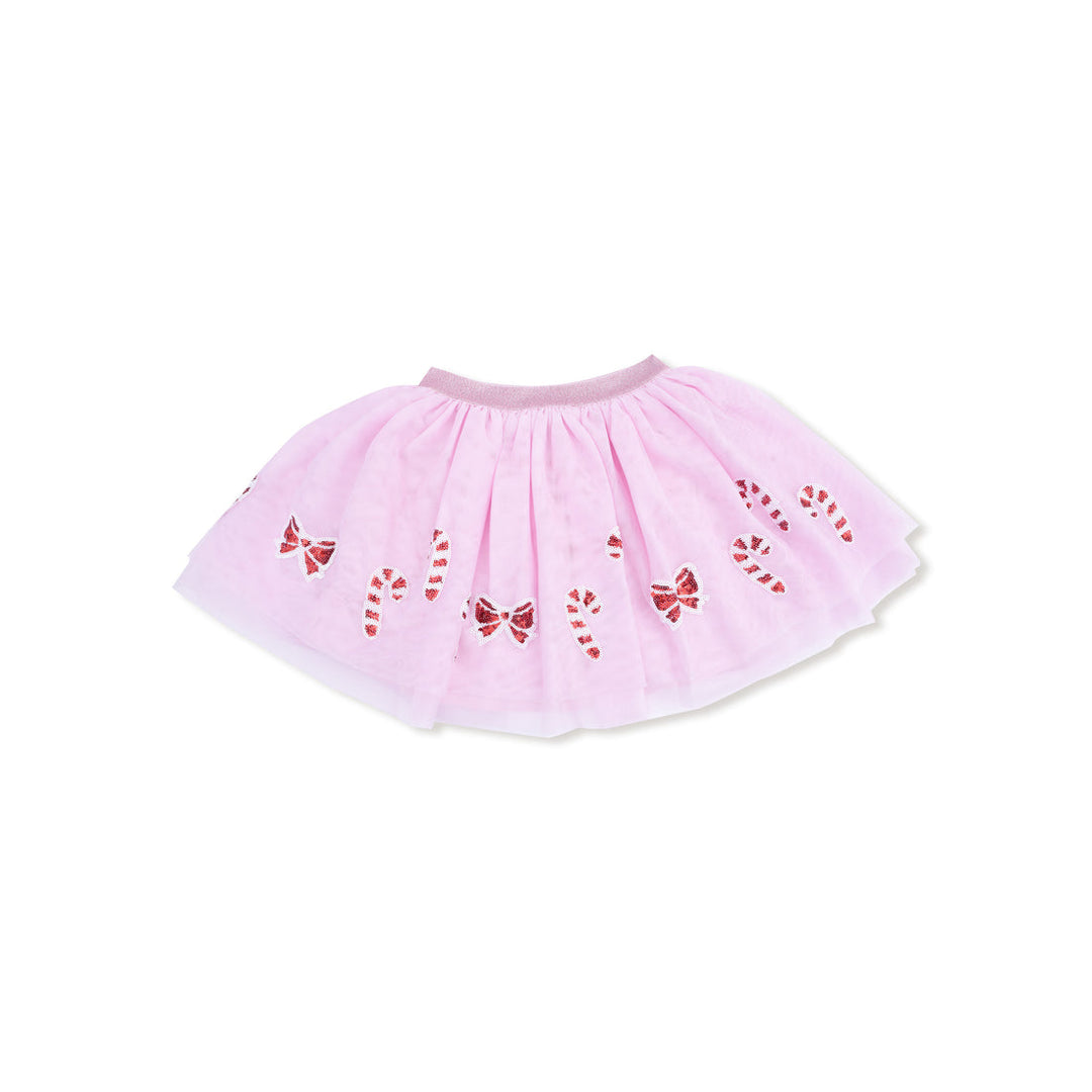 Pink tutu skirt with red bow and candy cane patterns on a white background