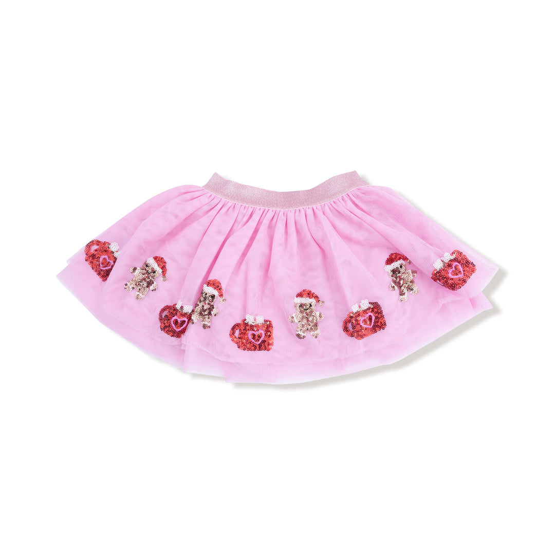 Pink tutu skirt with decorative gingerbread and cocoa mug elements on a white background