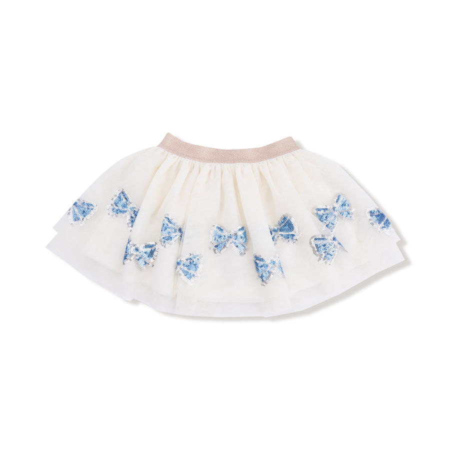White skirt with blue sequin bows along the bottom patterns on a white background