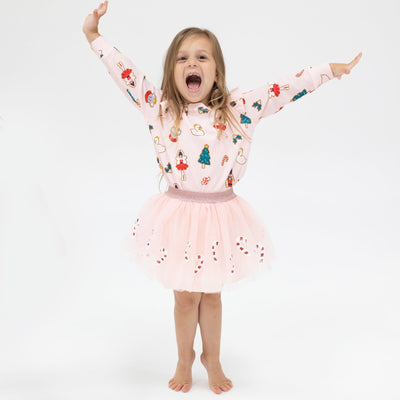 gingerbread cookies holiday themed all over light pink sweatshirt and a light pink tutu with red and white sequin candy canes along the bottom. 