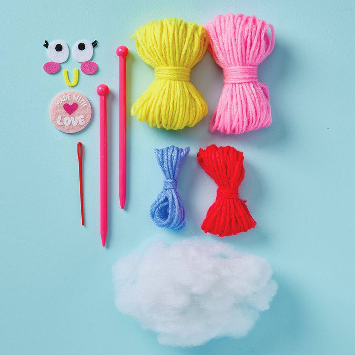 Colorful yarn balls and knitting needles on a light blue background