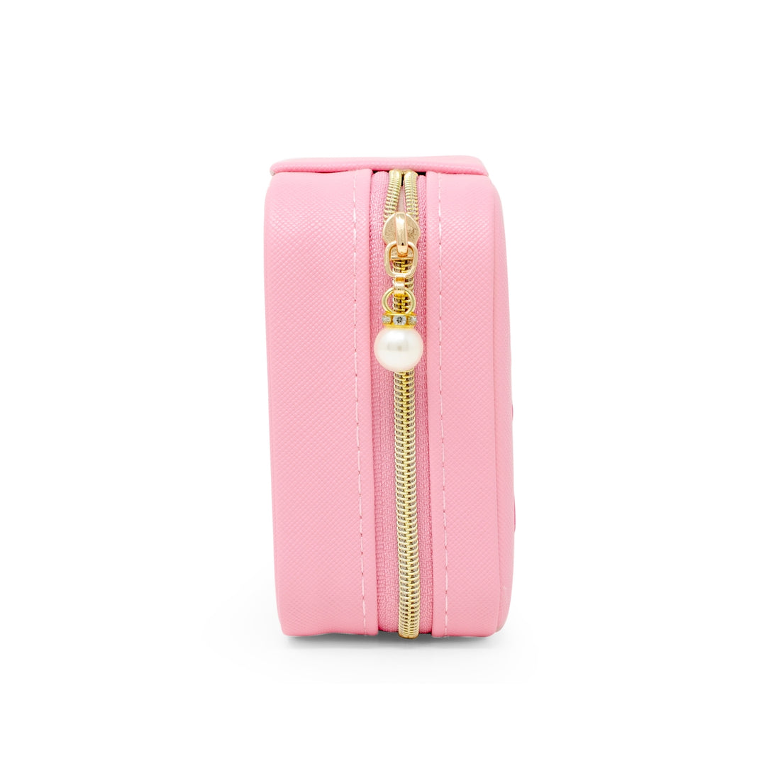 Pink cylindrical pouch with a gold zipper on a white background