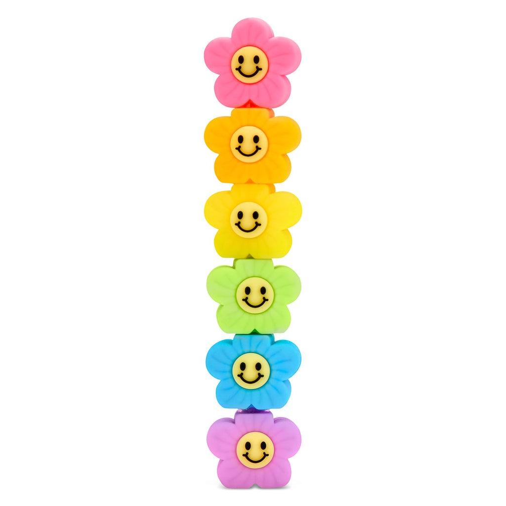 stackable markers shaped like flowers with smiley face centers. 