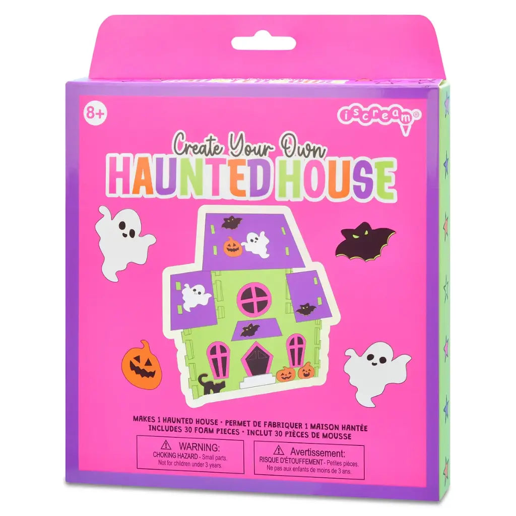 Packaging of 'Create Your Own Haunted House' craft kit with Halloween-themed graphics on a pink and purple background.