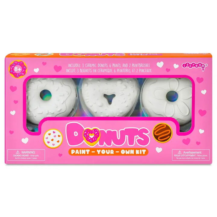 Paint your own donut kit packaging with three ceramic donuts and paint supplies on a white background.