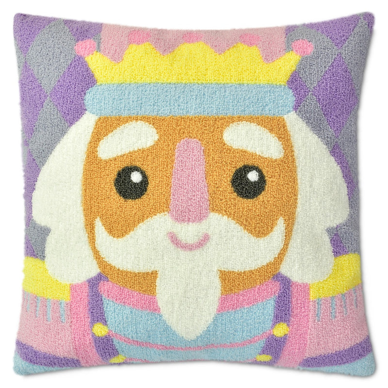 chenille pillow that has a design of a nutcracker in pastel shades of lavender, pink and yellow. 