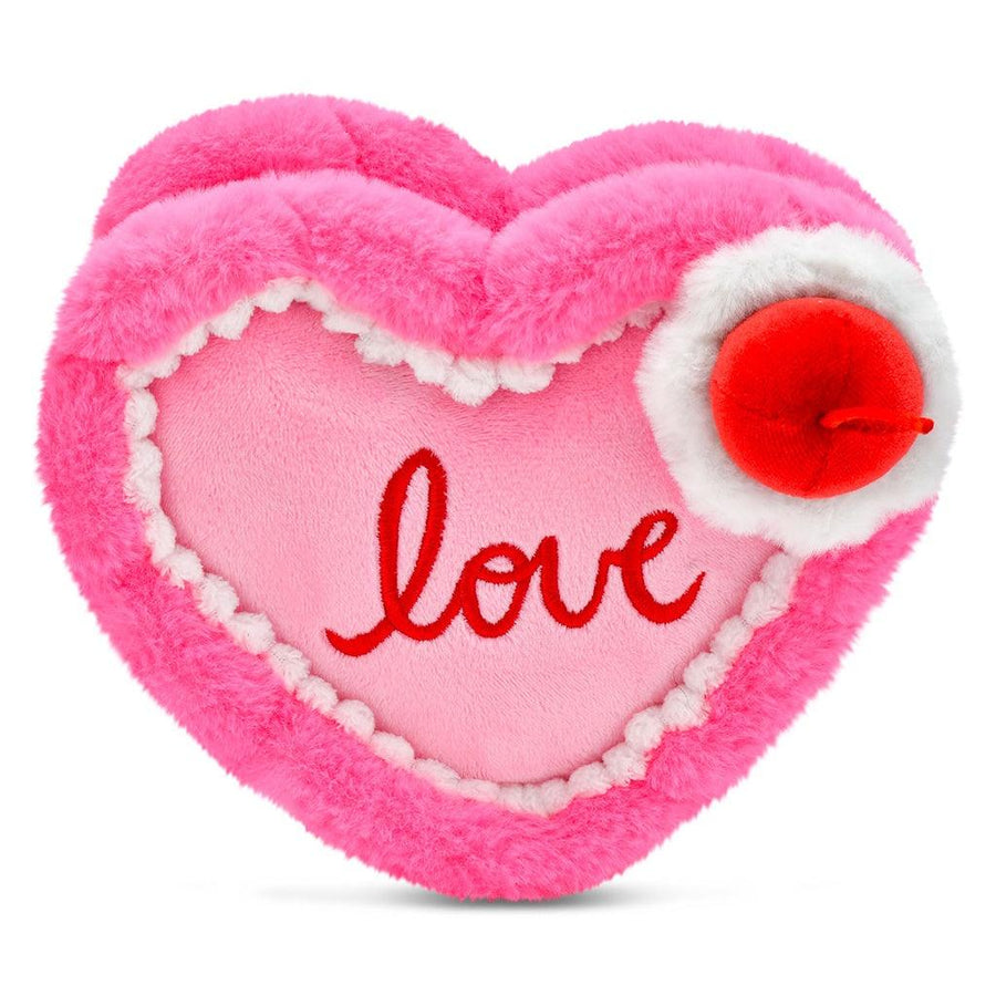 heart plush cake hot pink, light pink and whit frosting with the word 'love' written on it. a cherry on top