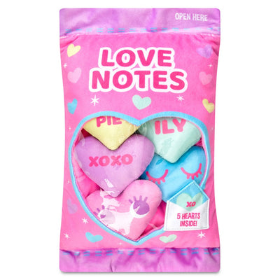 plush conversation hearts in a plush bag. PInk and purple in color. hearts are all multicolored. 