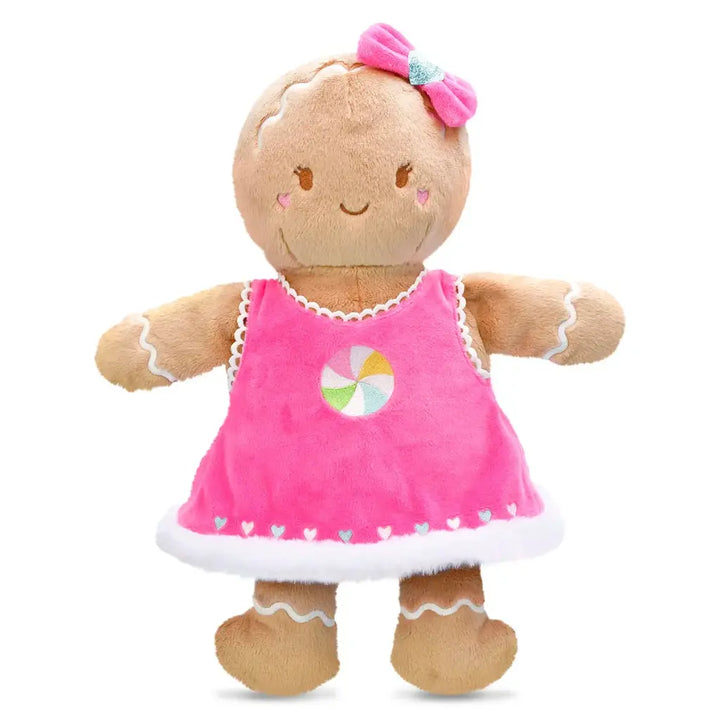 Plush gingerbread girl  toy with a pink dress and bow on a white background