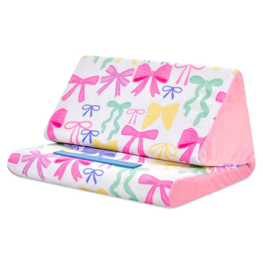 tablet pillow with white base and multi colored bows all over in pink, green, yellow and blue. 
