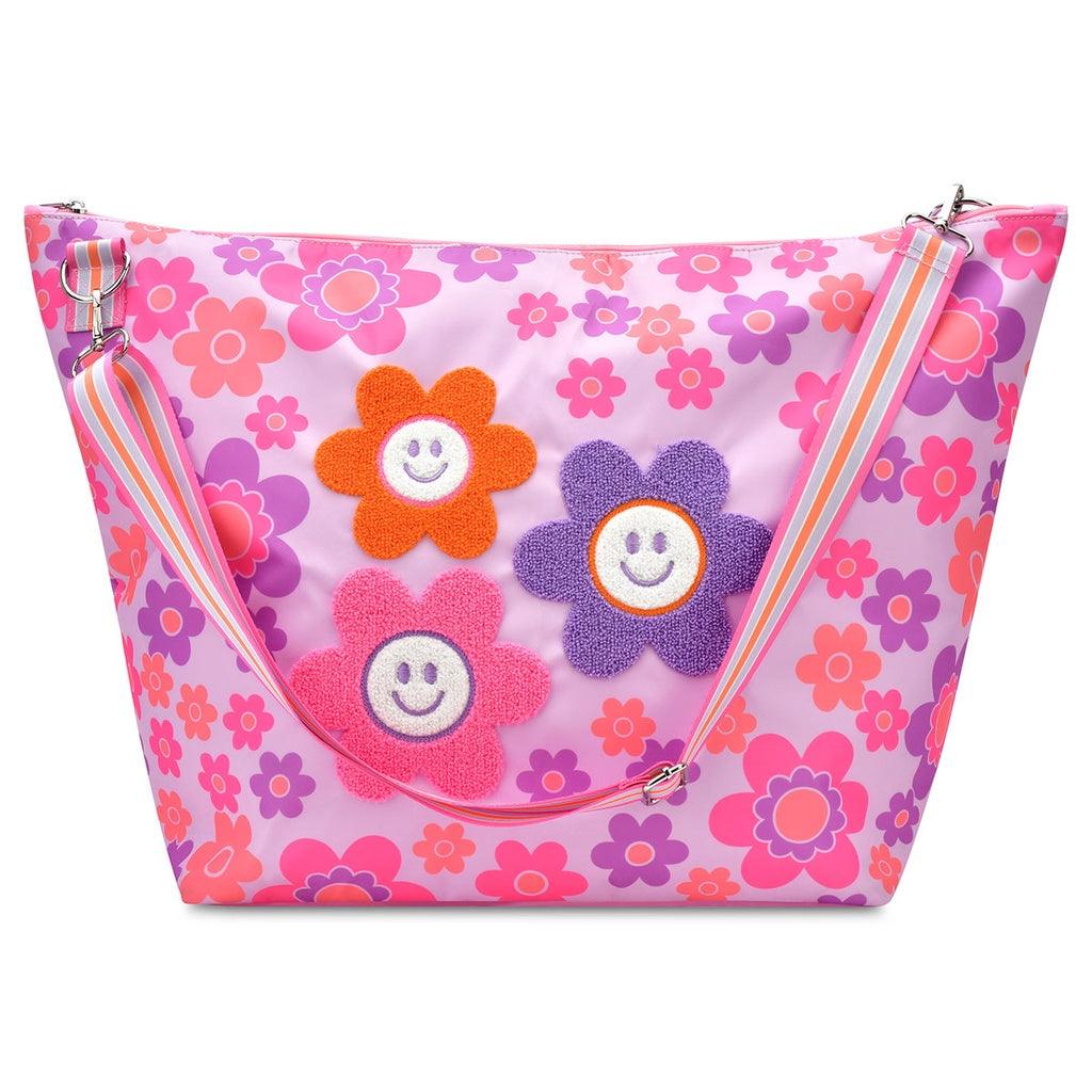 weekender tote with detachable strap. lavender background with daisies all over it. three big ones in the middle with a chenille daisy applique on it. 
