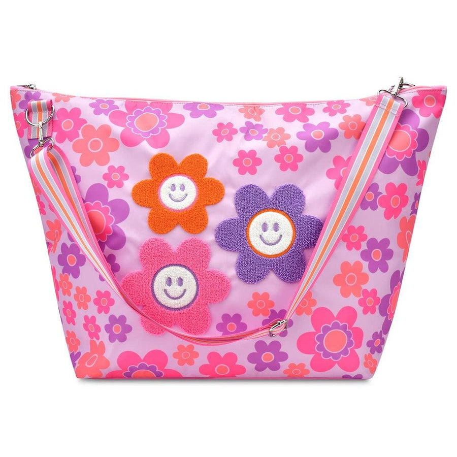 weekender tote with detachable strap. lavender background with daisies all over it. three big ones in the middle with a chenille daisy applique on it. 