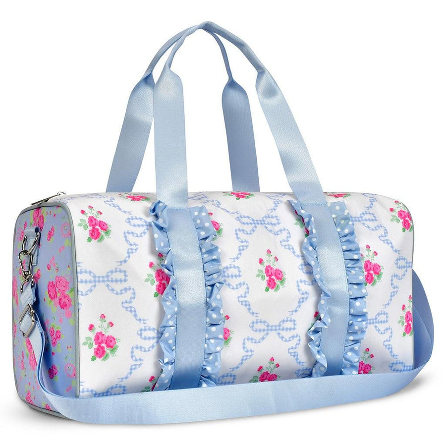 white duffel bag with blue handles and blue and pink floral background on the sides and white with blue ribbons and pink florals on the front and back. 