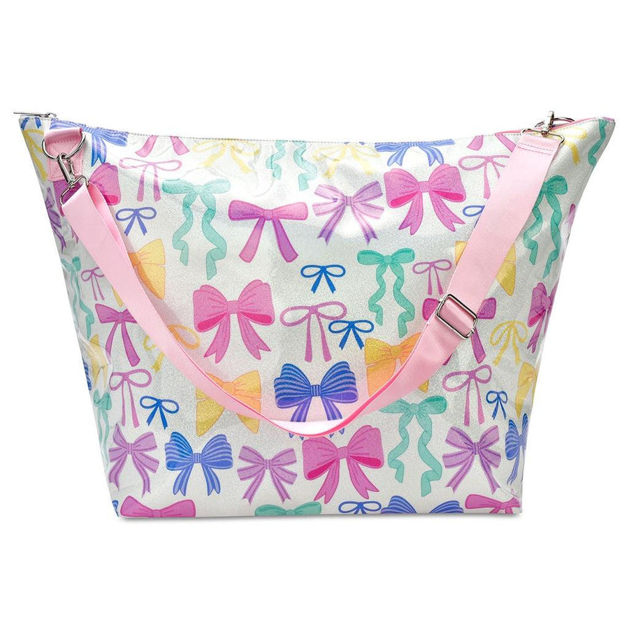 white weekender tote bag with pink shoulder strap for easy carrying. colorful bows all over the tote: pink, yellow, blue, and green 