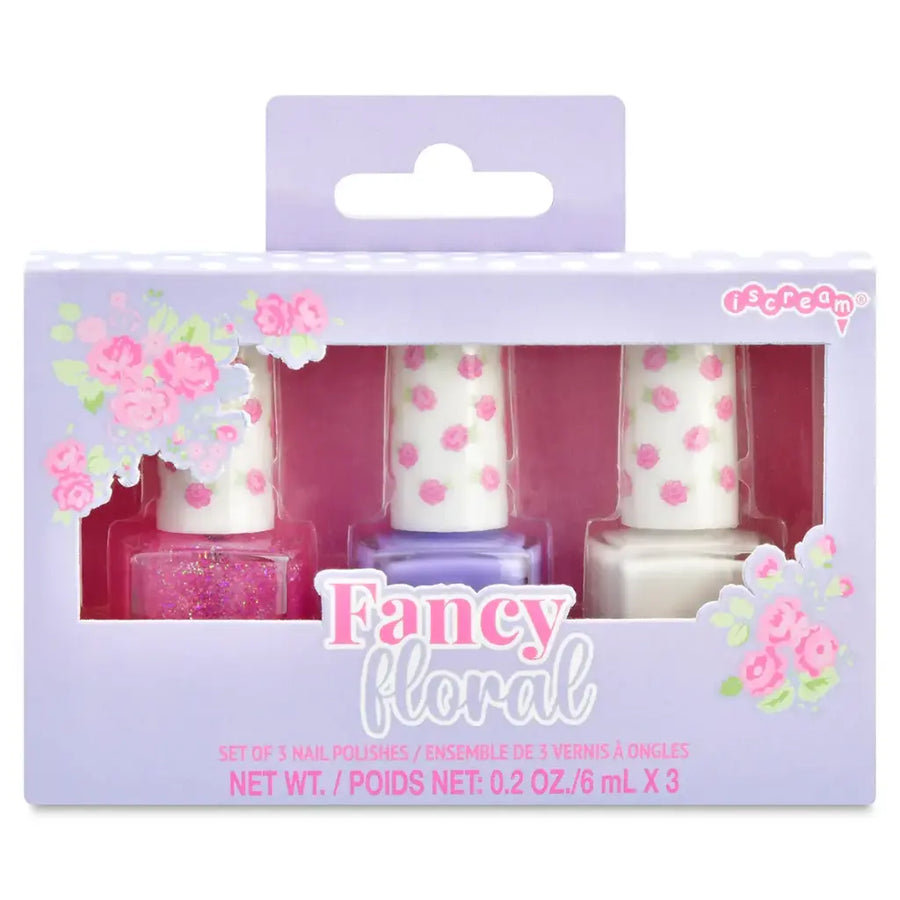 Packaged set of three nail polishes with floral design on packaging