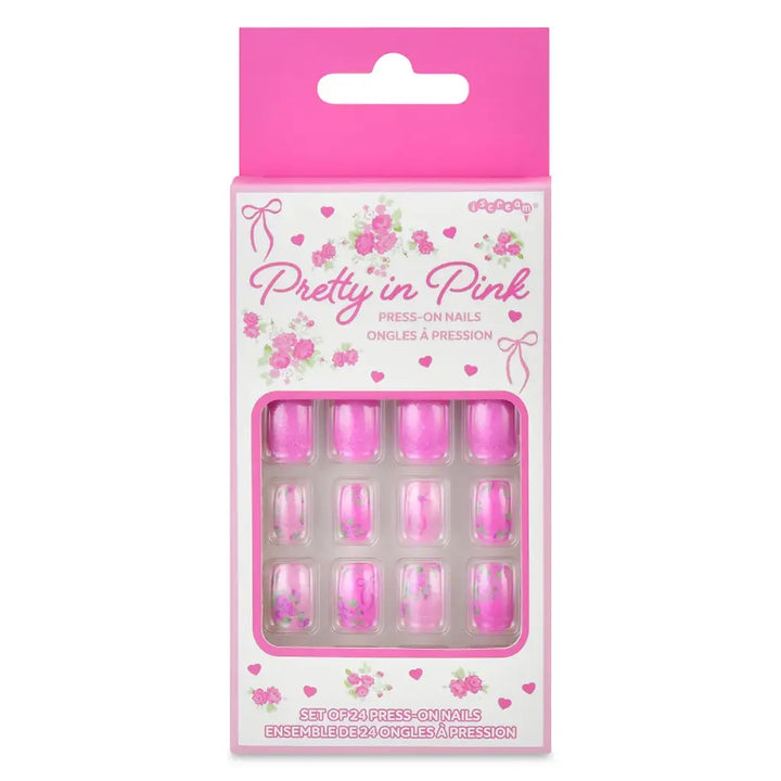 Pack of press-on nails with pink packaging featuring 'Pretty in Pink' text and floral designs.