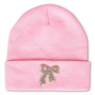 pink beanie with a rhinestone bow applique on the center of the brim