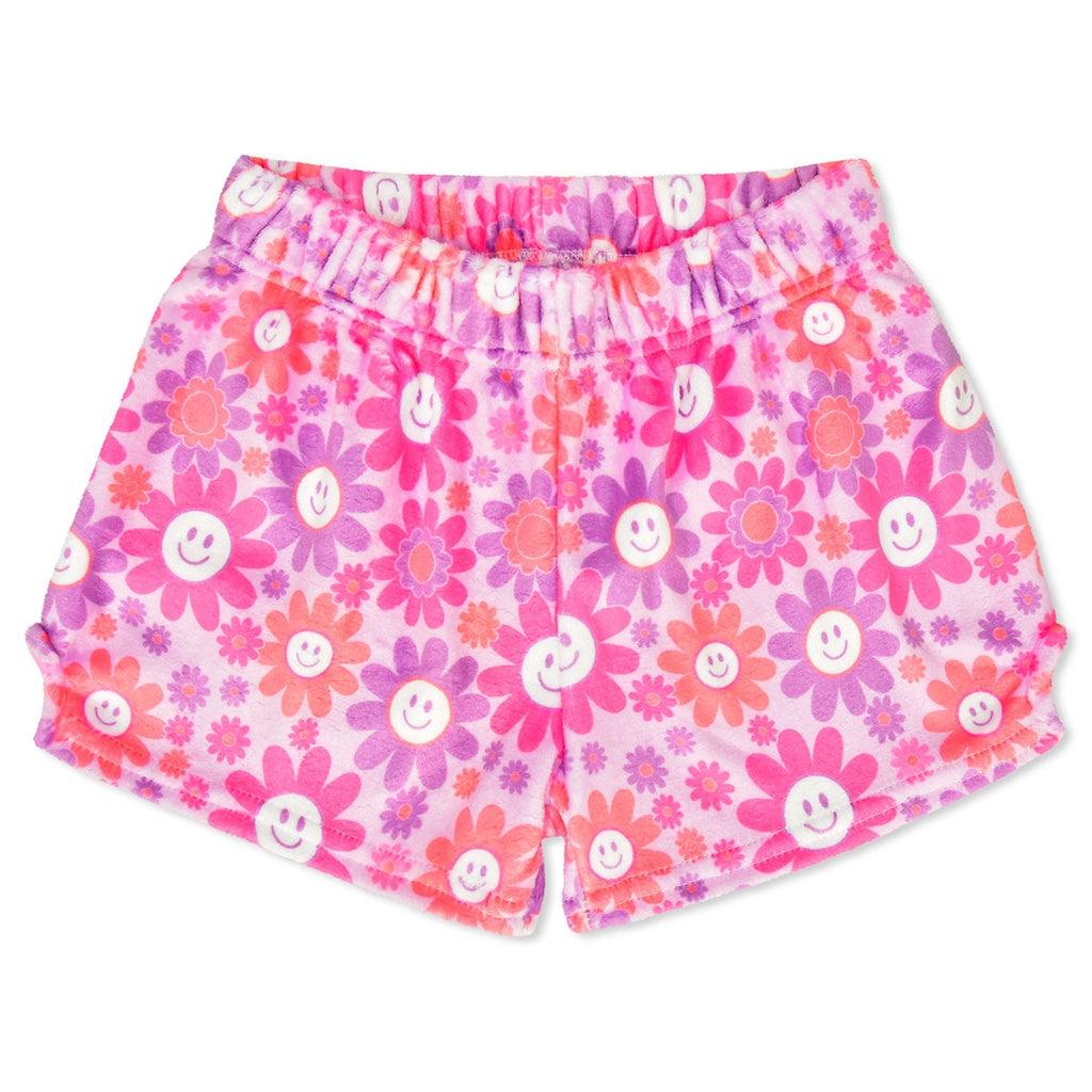 plush shorts with an elastic waist pink purple and orange colors. daisies all over. the large daisies have a smiley face in the center. 
