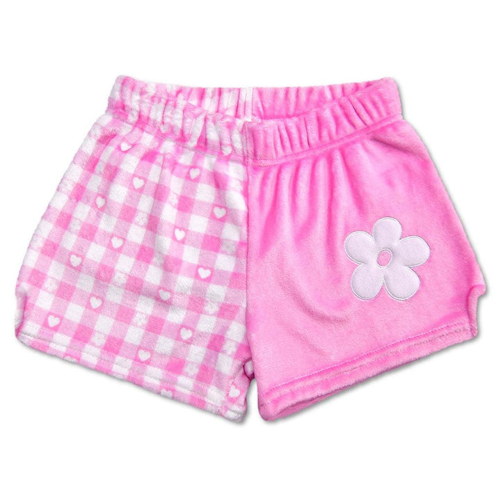 plush shorts: one leg is pink and white gingham check and the other is solid pink with a bg white diasy one it. 