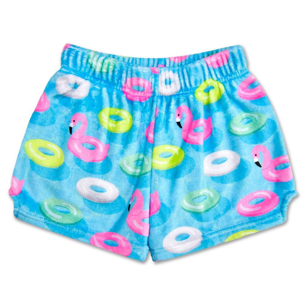 plush shorts in a bright blue with pool floats in different colors, one of them being a flamingo. 