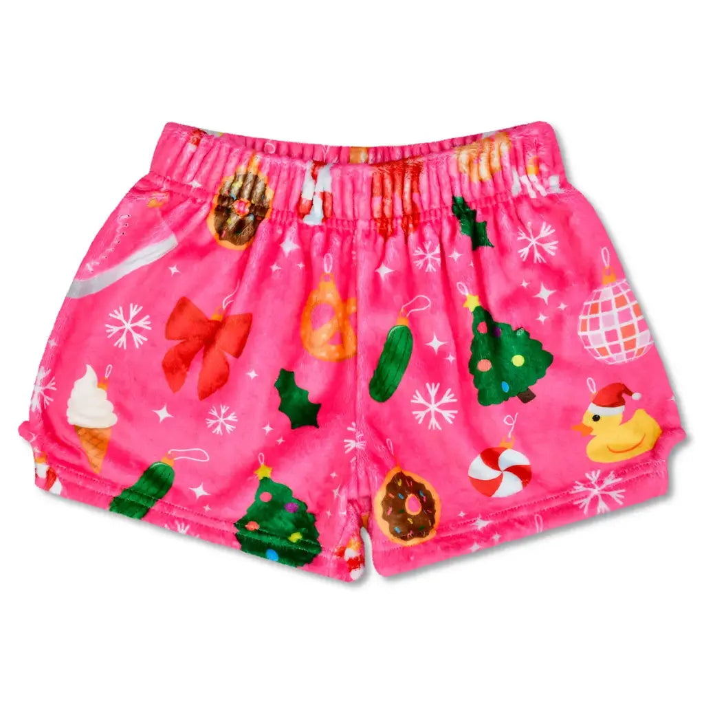 Pink children's shorts with Christmas-themed patterns on a white background