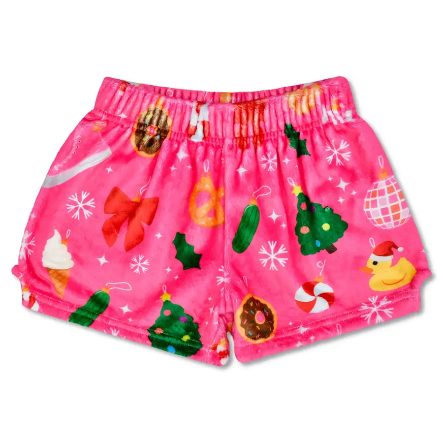 Pink children's shorts with Christmas-themed patterns on a white background