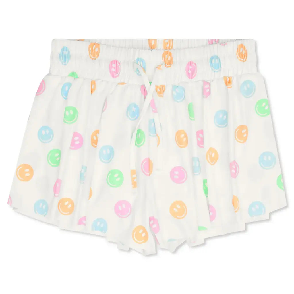 Pair of white shorts with colorful donut pattern on a white background