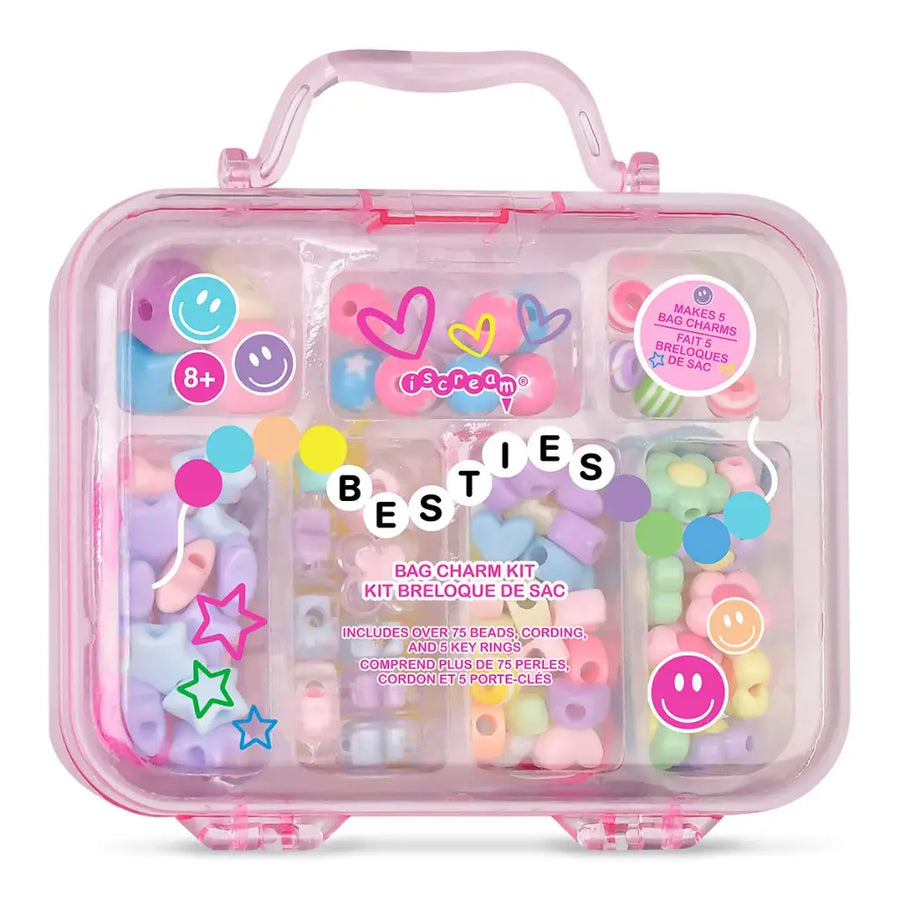 Pink plastic case with 'BESTIES' bag charm kit contents on a white background