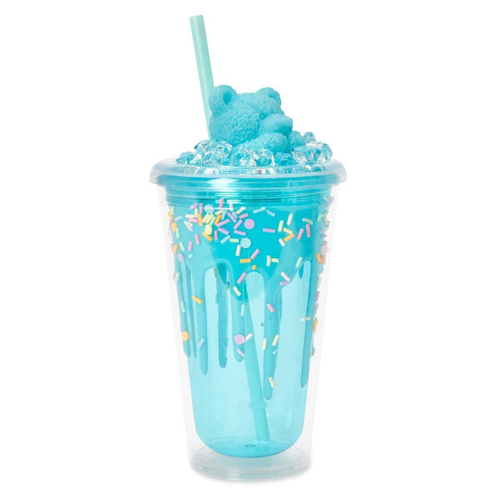plastic tumbler with straw and a blue bear sitting on the lid and sprinkles throughout the cup
