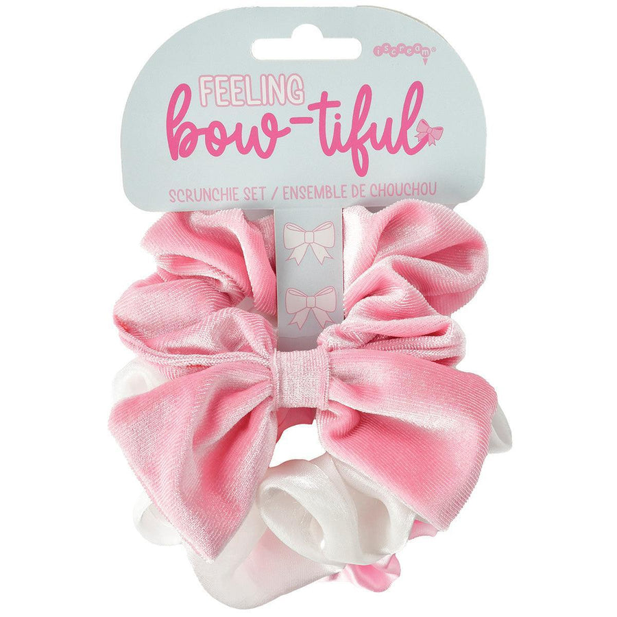 set of 3 scrunchies- one pink scrunchie with a bow attached to it. one white satin one and one pink one 