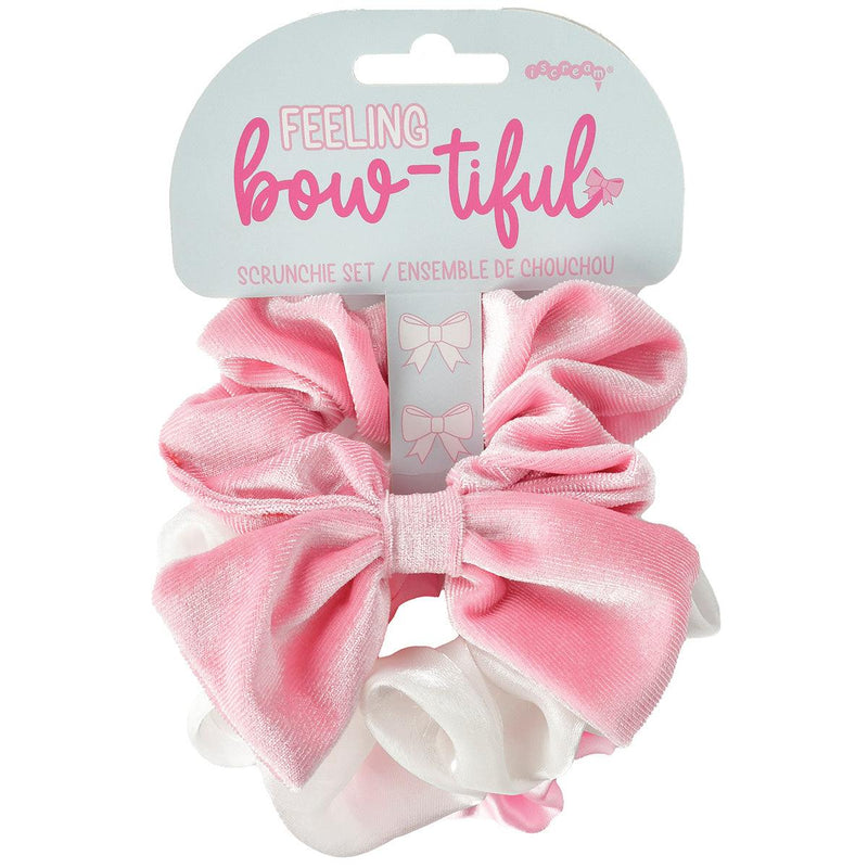 set of 3 scrunchies- one pink scrunchie with a bow attached to it. one white satin one and one pink one 