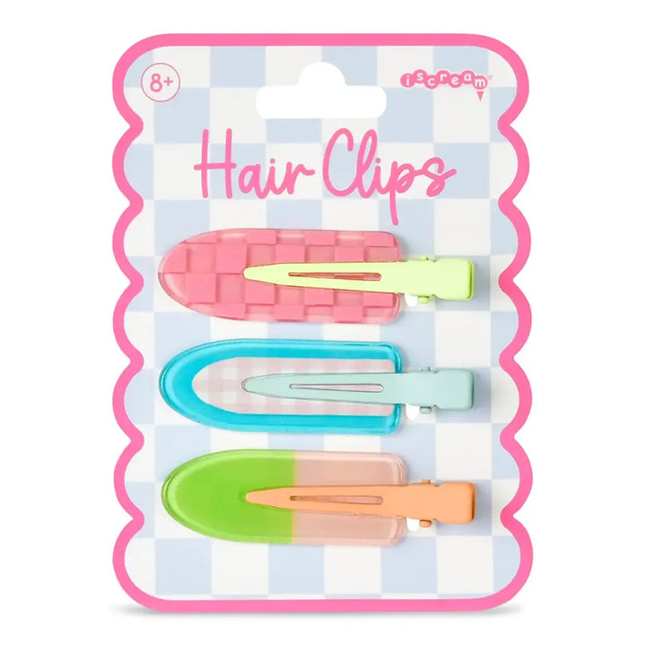 Packaged hair clips with colorful clips on a checkered background