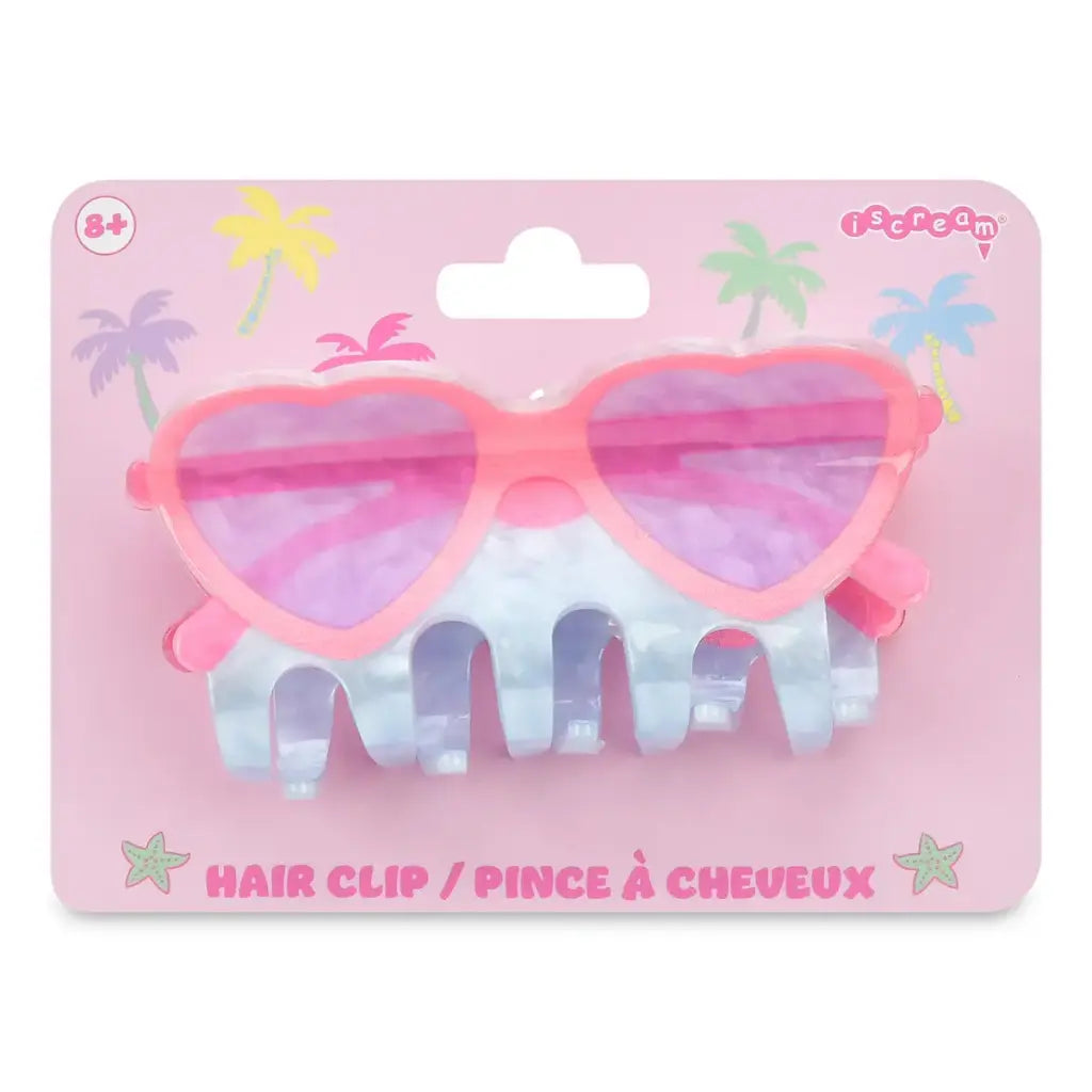 Heart-shaped hair clip with pink and purple design on a pink packaging background